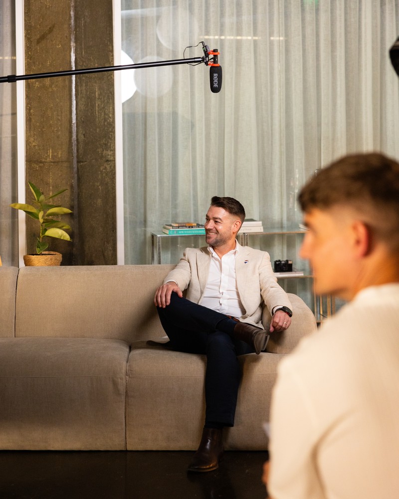 On set, filming an agent interview